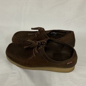 Woman’s dark brown Clark’s shoes with shoe strings